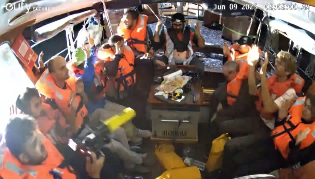 Activists wearing life jackets as Israeli naval forces board the Madleen.