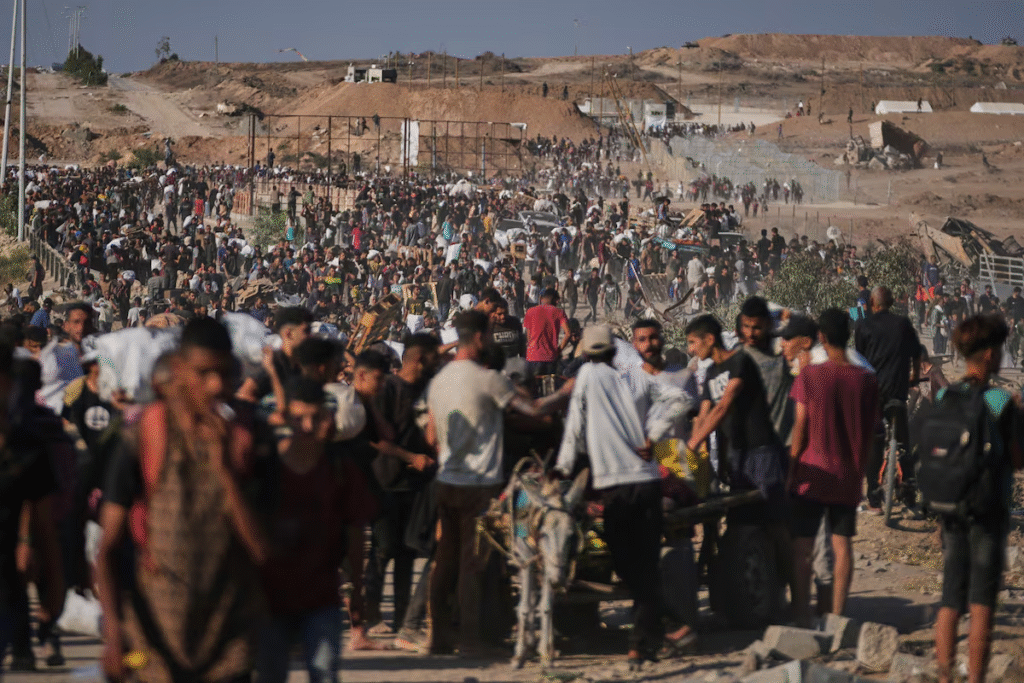 Palestinian waiting in long queues for aid distribution.